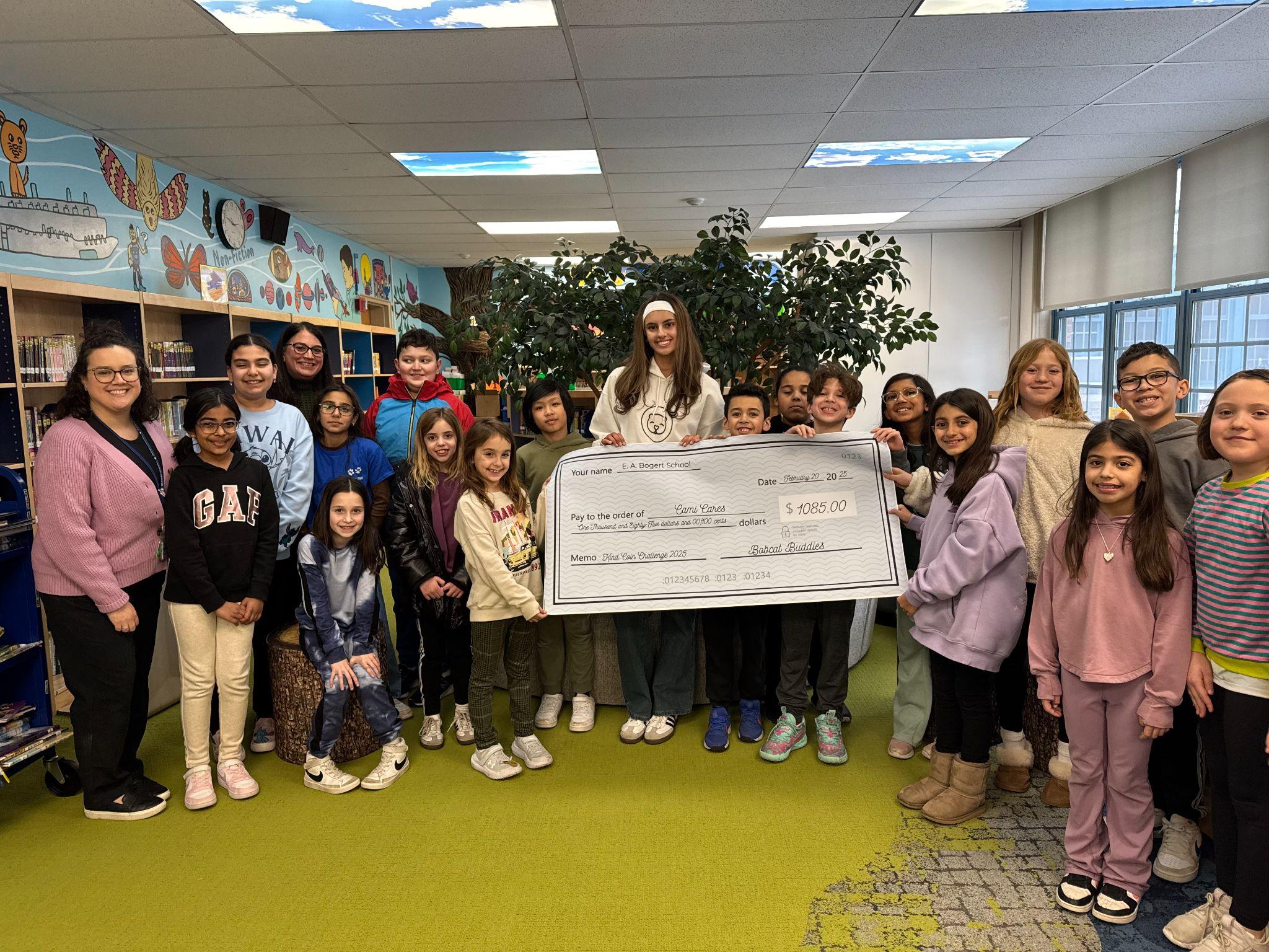 Students presenting fundraising check for Cami Cares